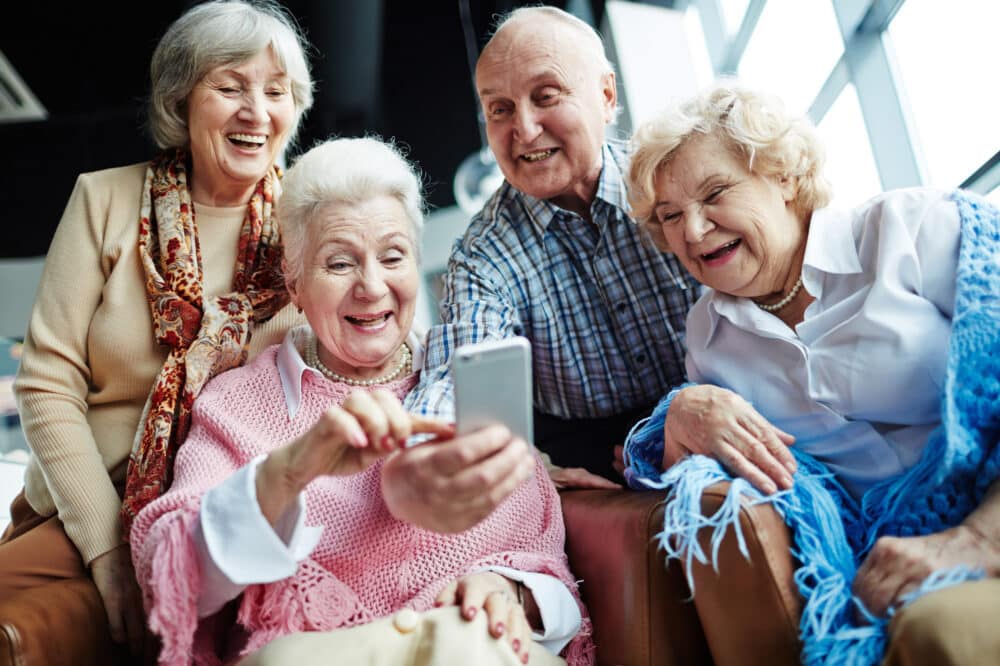 Elderly people with cellphone making their selfie at leisure
