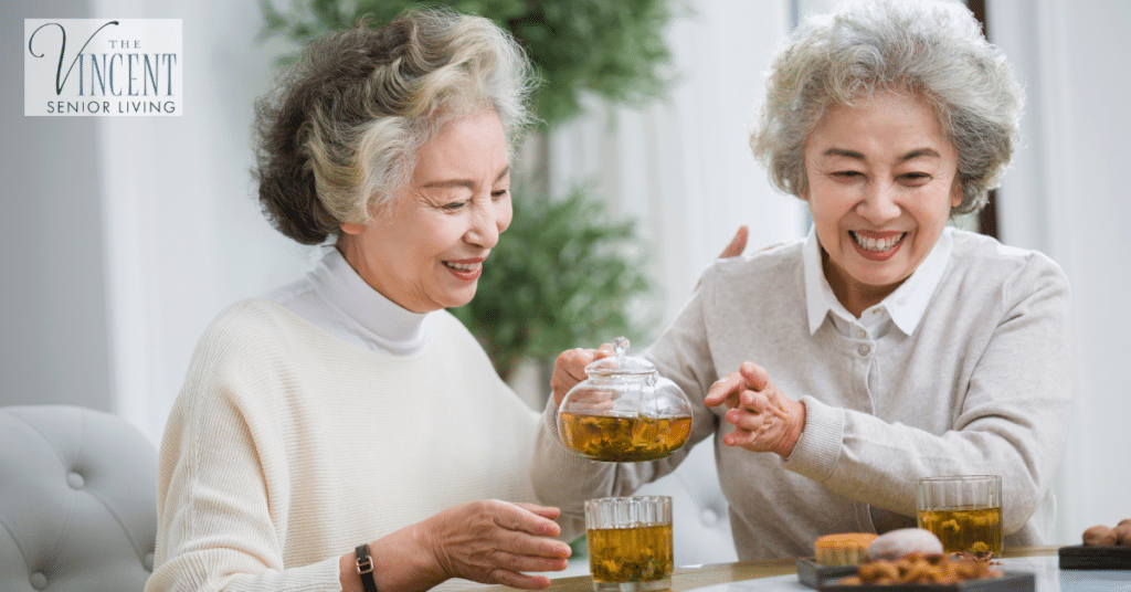 Happy senior women are talking and drinking green tea. Foods to prevent dementia. Healthy eating.
