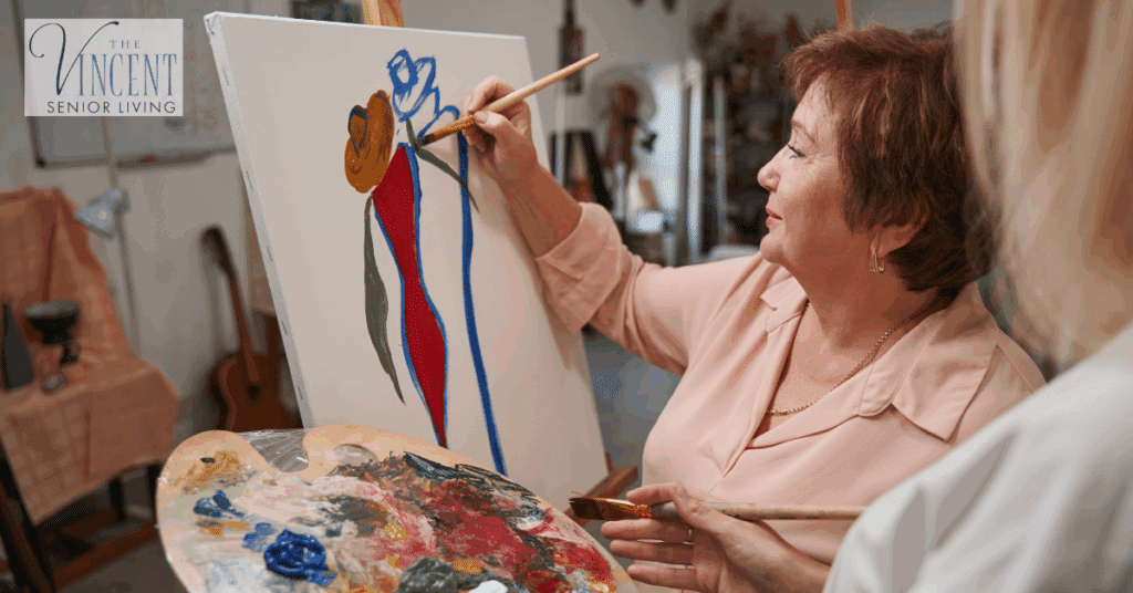 Art therapy and dementia – senior woman painting on canvas in supportive care setting