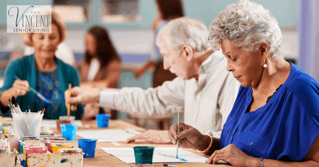 Art therapy and dementia – elderly group painting together in creative therapy session