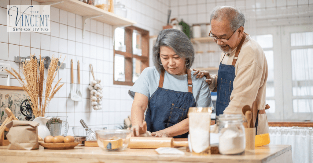 Activities for memory care: senior couple cooking together in a bright kitchen.