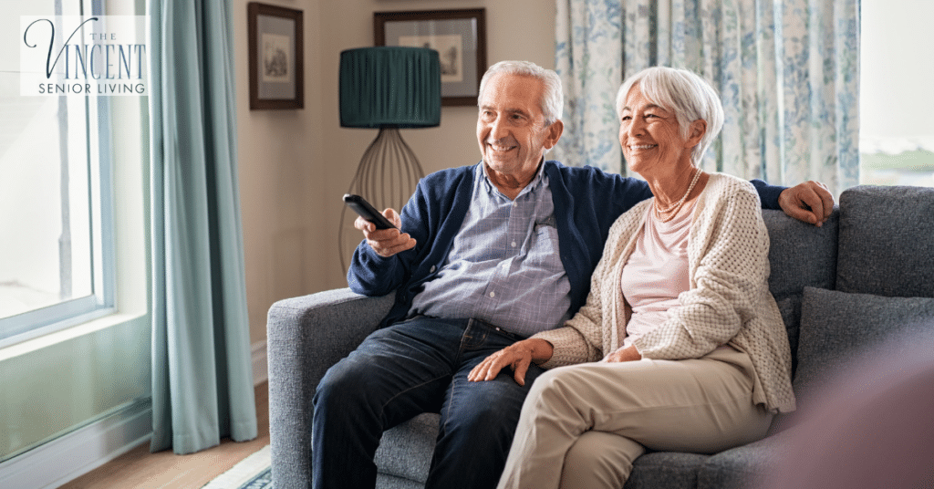 A senior couple relaxing on sofa watching Alzheimer's movies